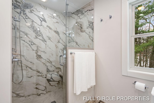 bathroom featuring a shower with shower door