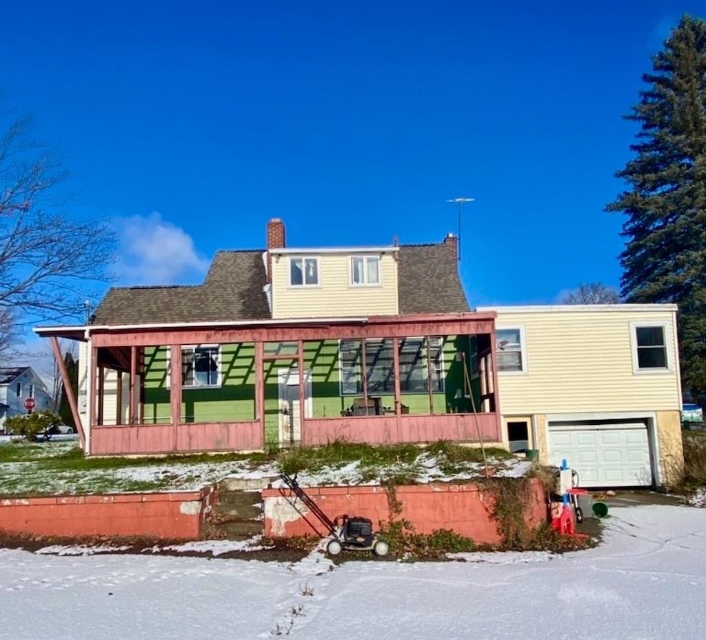 exterior space featuring covered porch and a garage