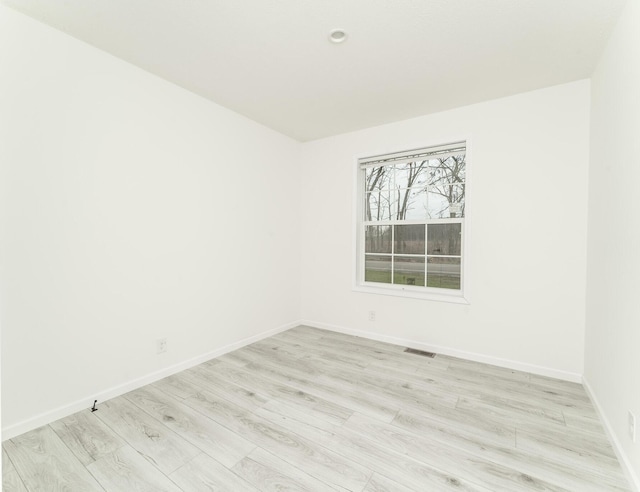 spare room with light hardwood / wood-style floors