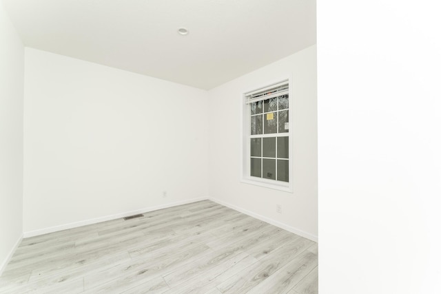 unfurnished room with light hardwood / wood-style floors