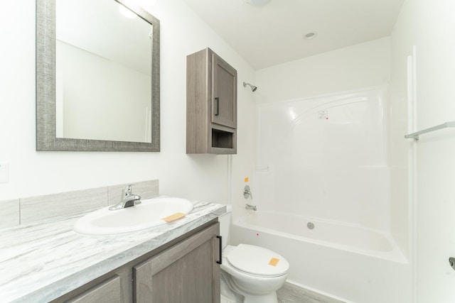 full bathroom with shower / bathing tub combination, vanity, toilet, and hardwood / wood-style floors