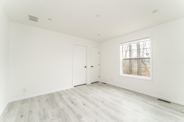 spare room featuring light hardwood / wood-style floors