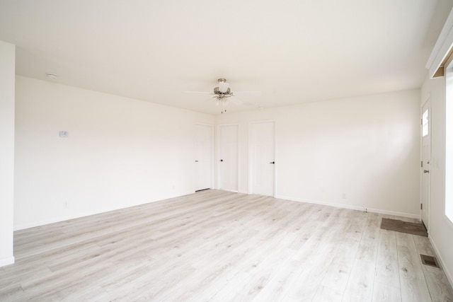 unfurnished room with ceiling fan and light wood-type flooring