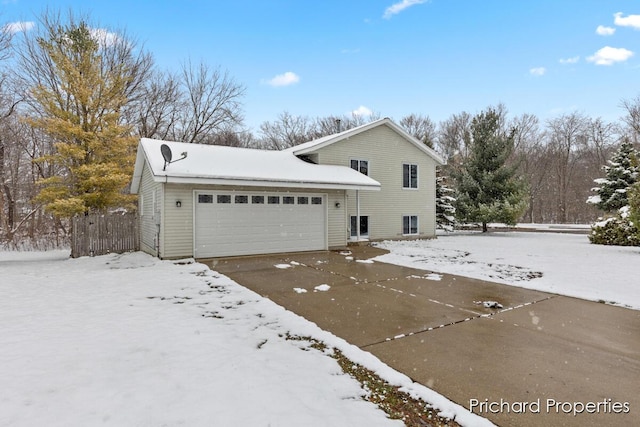 view of snow covered exterior featuring a garage