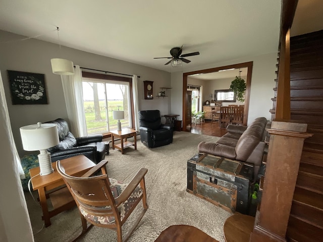 carpeted living room with ceiling fan