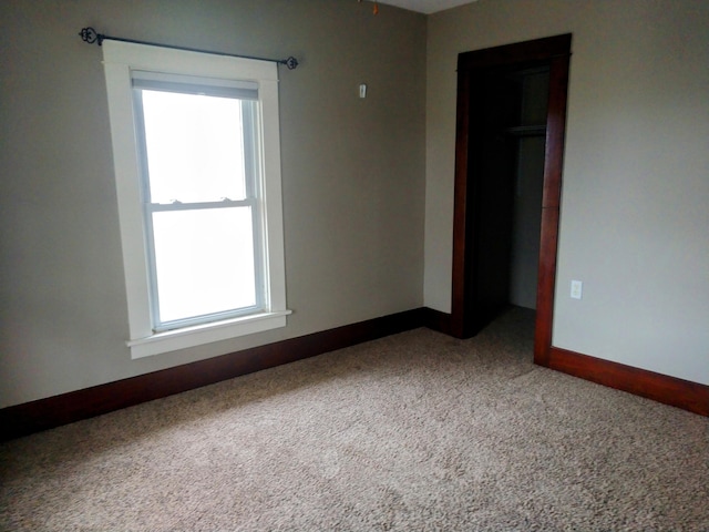 empty room with carpet floors and plenty of natural light