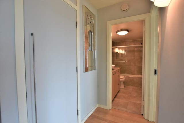 hallway with light hardwood / wood-style flooring