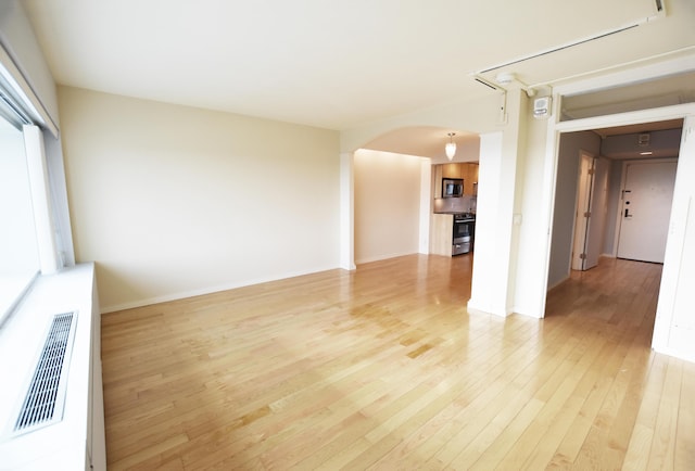 spare room featuring light hardwood / wood-style floors