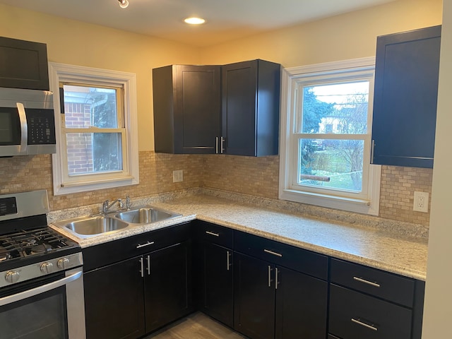 kitchen with stainless steel appliances, tasteful backsplash, and sink