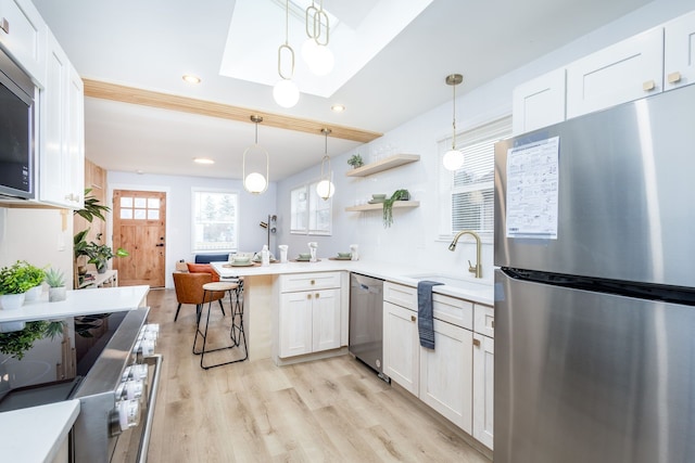 kitchen with white cabinetry, sink, and stainless steel appliances