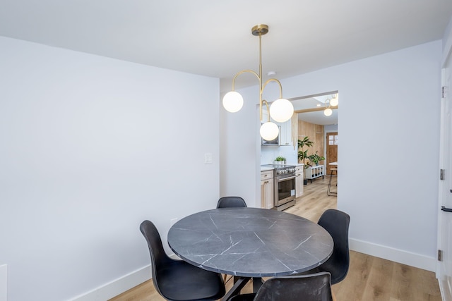 dining area with an inviting chandelier and light wood-type flooring