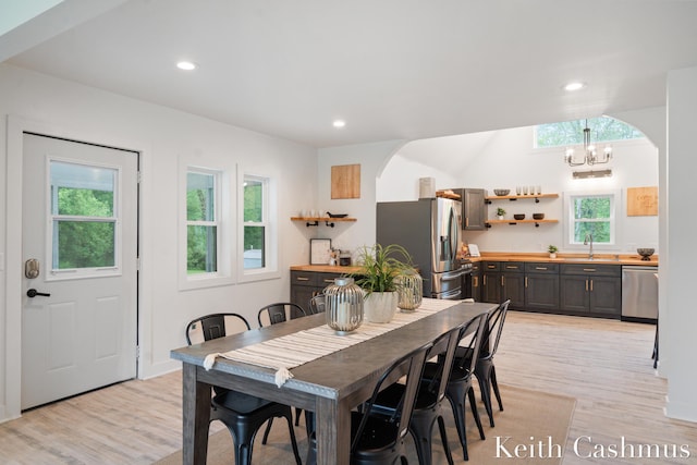 17513 M 140th Hwy, South Haven, MI 49090 - dining room with light wood-style flooring, a chandelier, recessed lighting, and arched walkways