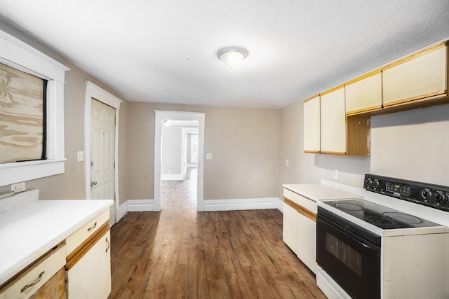 kitchen featuring dark hardwood / wood-style floors and electric stove