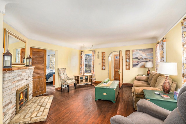 living room featuring dark hardwood / wood-style flooring and a brick fireplace