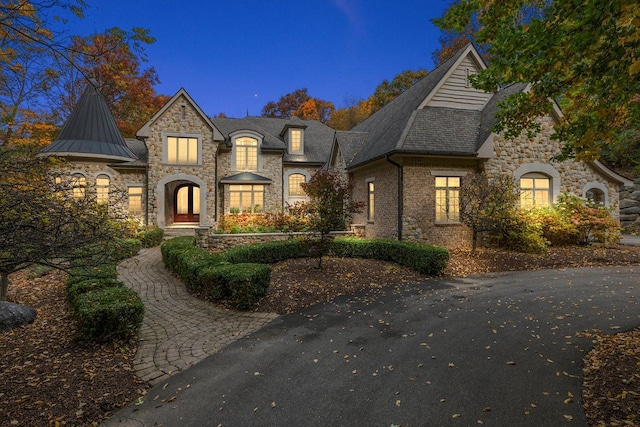 french country inspired facade with a standing seam roof and metal roof