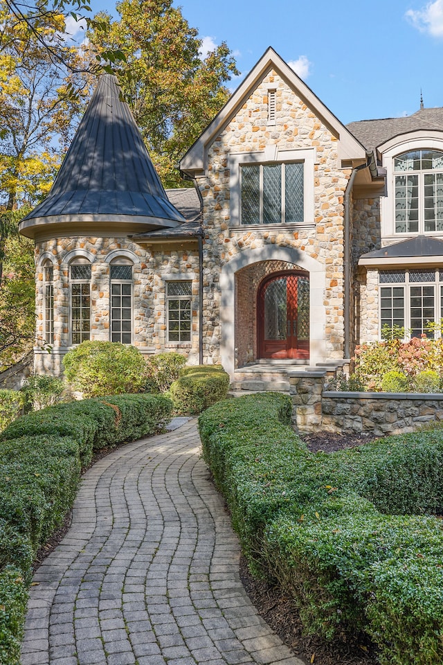 french provincial home with a standing seam roof and metal roof