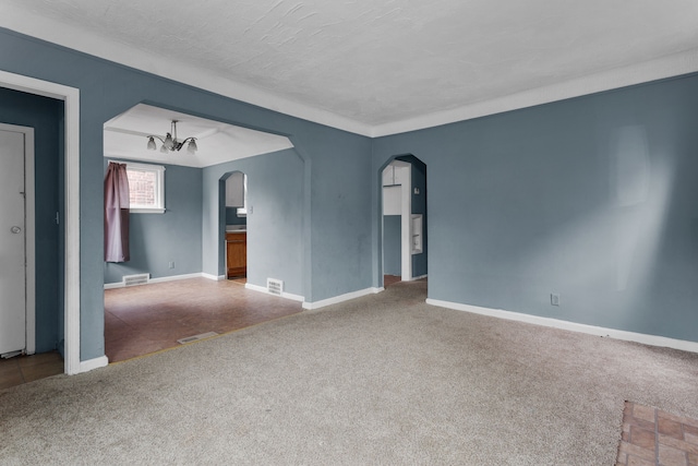 unfurnished room with a notable chandelier, carpet floors, and a textured ceiling