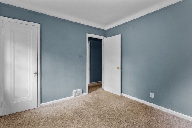 unfurnished bedroom with carpet floors and ornamental molding