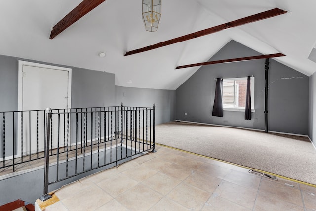 additional living space featuring vaulted ceiling with beams and light carpet