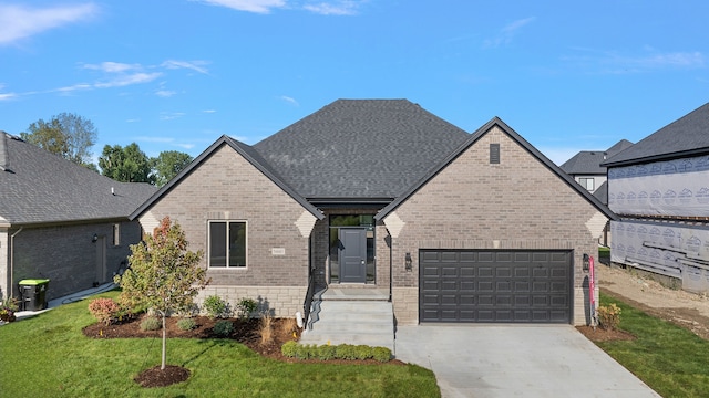 view of front of property featuring a garage and a front yard