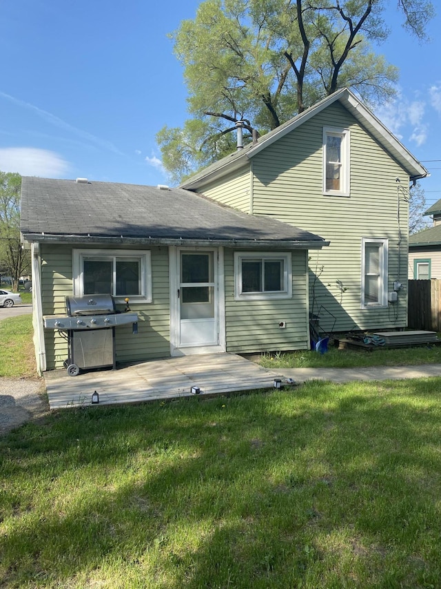 rear view of house with a yard