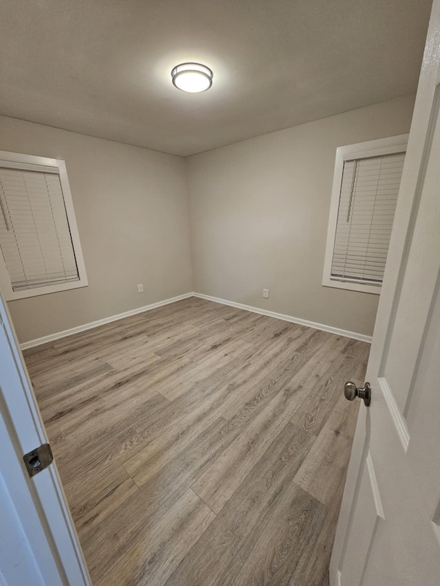 unfurnished room with light hardwood / wood-style floors