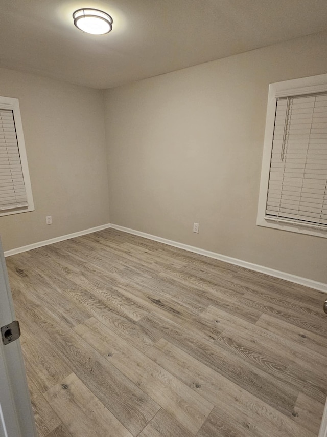 spare room with light hardwood / wood-style floors