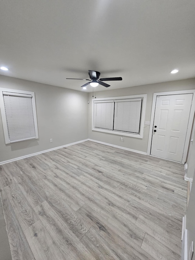 unfurnished room with ceiling fan and light wood-type flooring