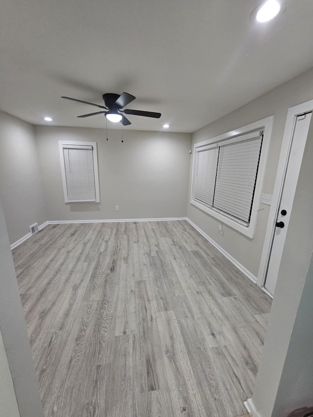 unfurnished room featuring ceiling fan and light wood-type flooring