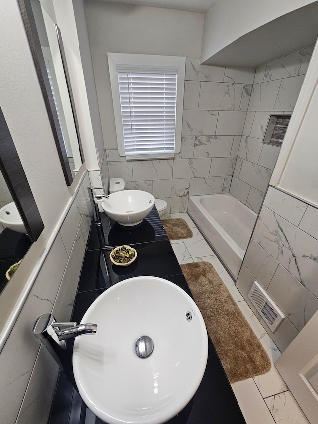 full bathroom featuring tile walls, vanity, independent shower and bath, and toilet