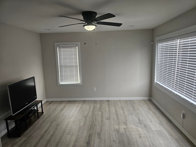 unfurnished living room featuring ceiling fan and light wood-type flooring