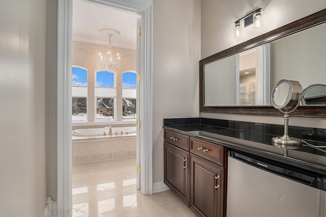 full bath with vanity, an inviting chandelier, crown molding, tile patterned floors, and a bath