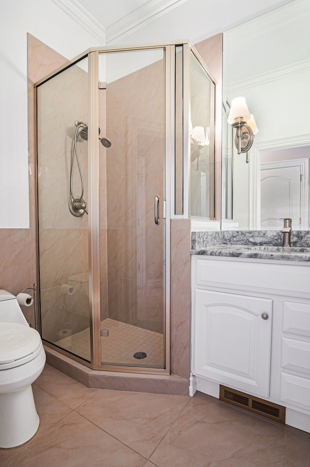 bathroom with a shower with door, vanity, ornamental molding, and toilet