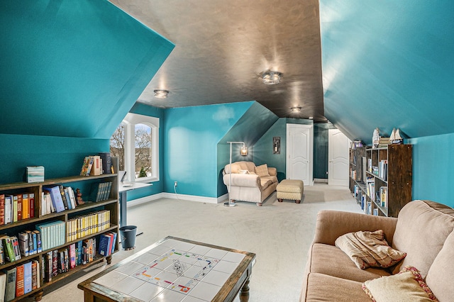 interior space with vaulted ceiling and baseboards