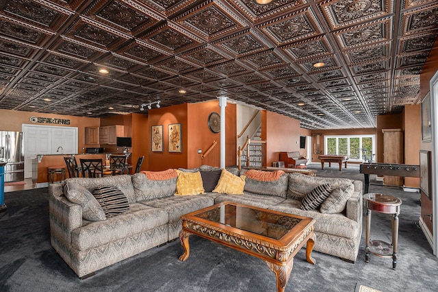 living area featuring stairway and an ornate ceiling