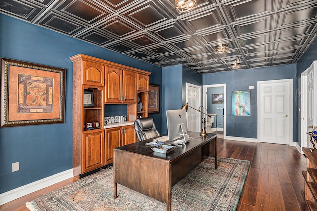 home office featuring baseboards, an ornate ceiling, and dark wood-style flooring