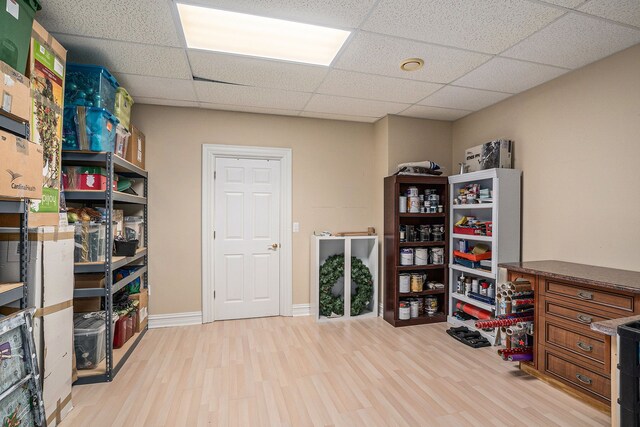 miscellaneous room with light hardwood / wood-style flooring and a drop ceiling