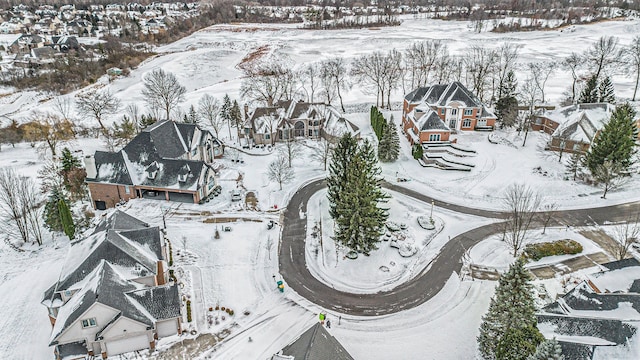 snowy aerial view with a residential view