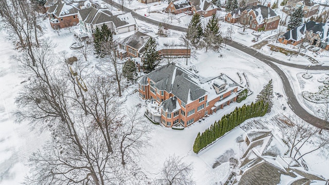 snowy aerial view featuring a residential view