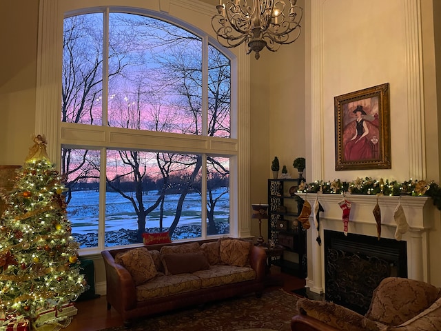 living room featuring a chandelier and a fireplace