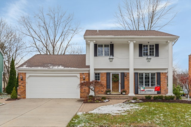 view of front of property featuring covered porch, a front yard, and a garage