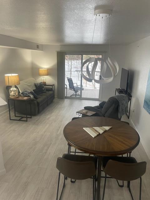 dining area featuring hardwood / wood-style floors and a textured ceiling