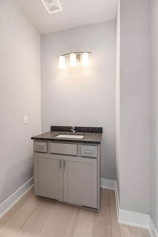 bathroom featuring hardwood / wood-style floors and vanity