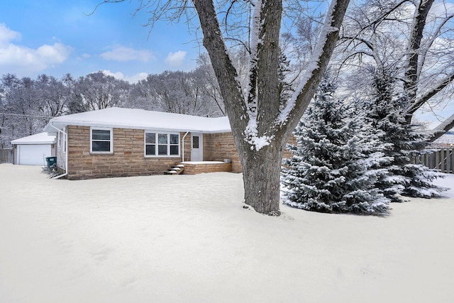 ranch-style house with a garage and an outbuilding