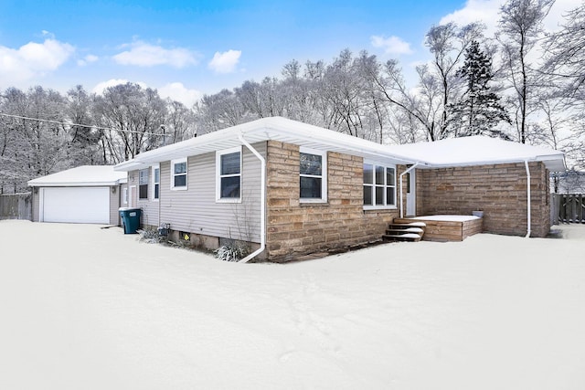 view of front of house with a garage and an outdoor structure