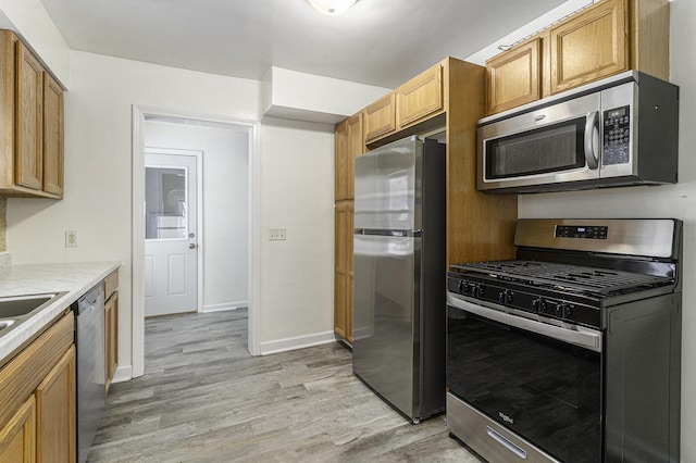 kitchen with stainless steel appliances and light hardwood / wood-style flooring