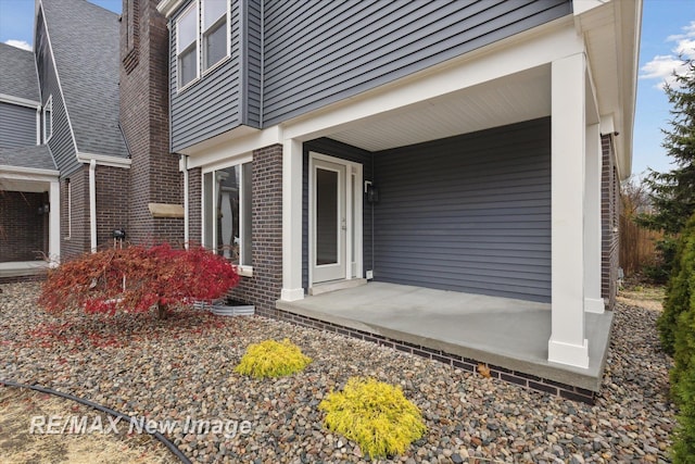 60 Golfview Dr, Saginaw, MI 48638 - entrance to property featuring brick siding and covered porch