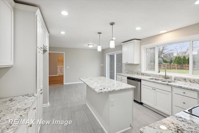 kitchen with dishwasher, sink, hanging light fixtures, white cabinets, and a kitchen island