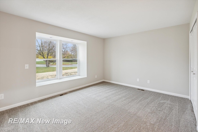 unfurnished room featuring carpet