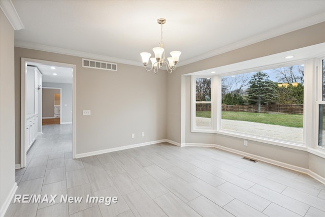 empty room featuring a notable chandelier and crown molding